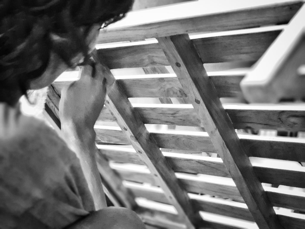 Muebles Asia - Person working on furniture black and white